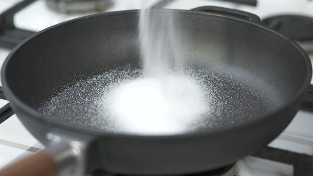 Cleaning New Cast Iron Cookware Heating Skillet With Salt.