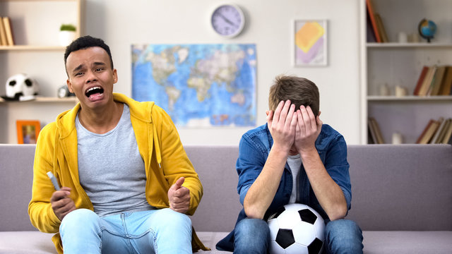 Multiracial Teenager Friends Disappointed About Favorite Football Team Losing