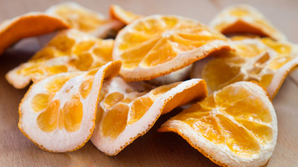 Fototapeta na wymiar Natural Oranges Dried Sliced on a Wooden Background