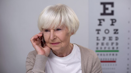 Senior lady making appointment with oculist, age related diseases prevention