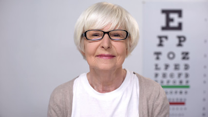 Senior female in eyeglasses smiling to camera, satisfied with service quality