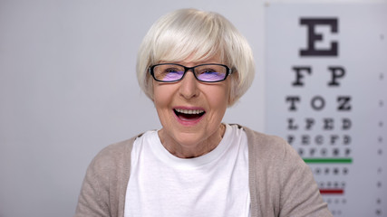 Extremely happy retired woman enjoying perfect eye sight in new glasses, health