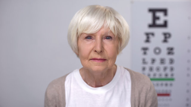 Retired female focusing vision during examination, ophthalmological check-up