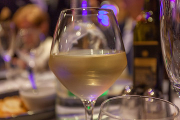 Glass of white wine with bokeh effect background