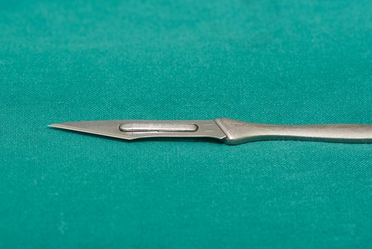 Surgical knife on a green sheath in opearating room