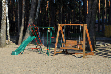 a children's playground set on a public beach.