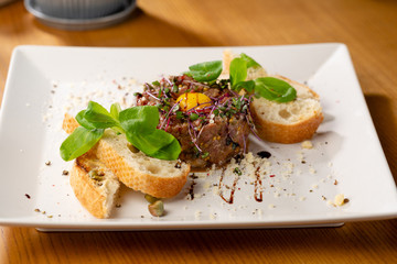 Tartar with eggs on white plate