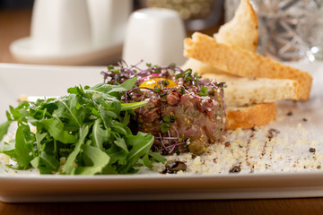 Tartar with eggs and toasted bread close-up