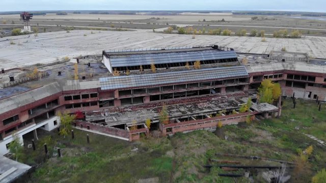 Abandoned airport buildings in middle of dirty fiield