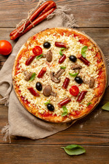 Pizza with sausage and mushrooms top view