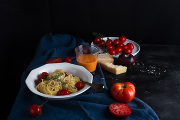 Italian pasta spaghetti with fried cherry tomato and thyme, side view
