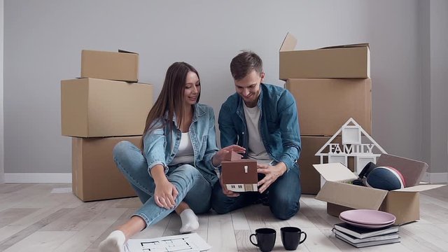 Young caucasian couple in love planning design of new home and furniture.