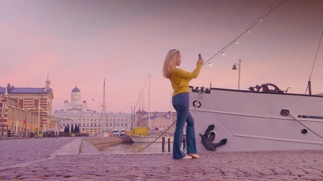 Happy Tourist Woman Takes Photos In Helsinki Harbor