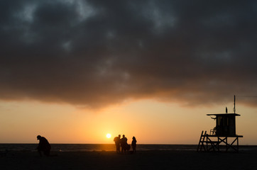 Beach rescue station near Newport Beach Pier highlighted by sunset