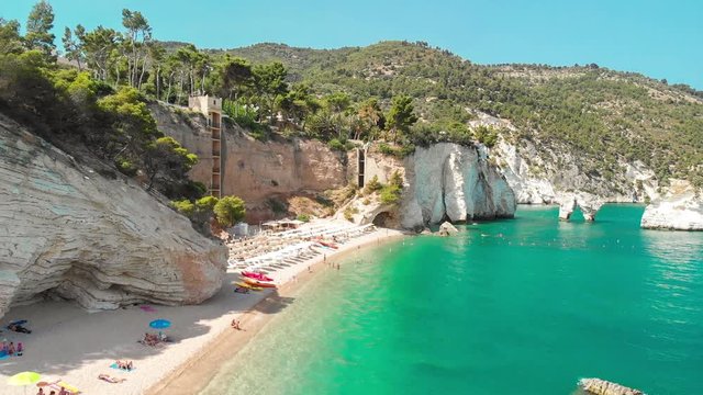 View from Puglia, Italy - Beach and faraglioni rocks formation (stacks, coastal rocks eroded by waves) -  Faraglioni di Puglia Baia delle Zagare