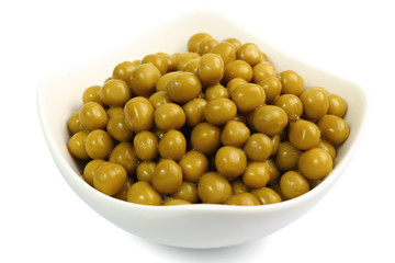canned green peas in a bowl isolated on white