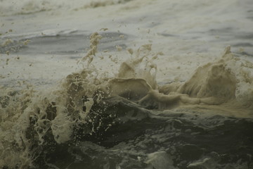 Surfing the waves on the beach of Matosinhos in Porto, Portugal. August 2019