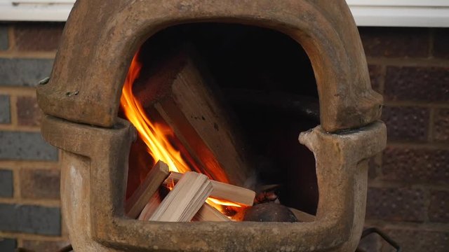 Wood burning in a chiminea in slow motion