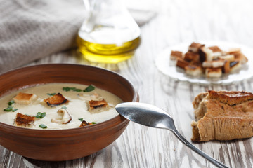 Grandma's mushroom soup with croutons  close-up on the table.
