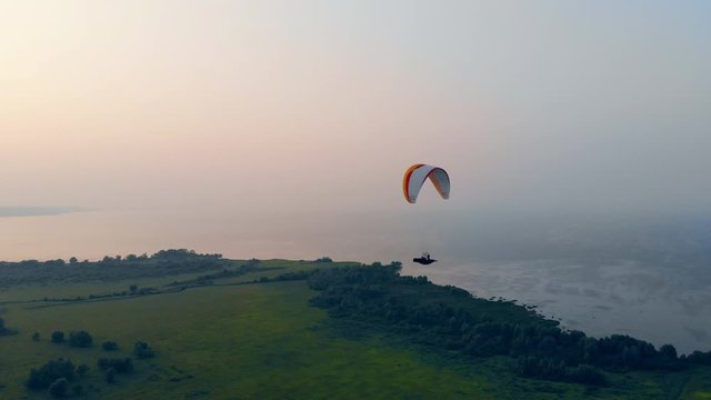 Parafoil is flying fast above the terrain