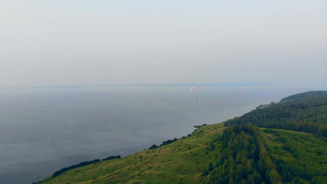 Waterscape with forests and the parafoil floating above