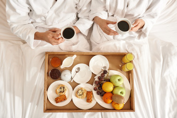 Everything. Right, where you need it. Couple relaxing in hotel room wearing robes