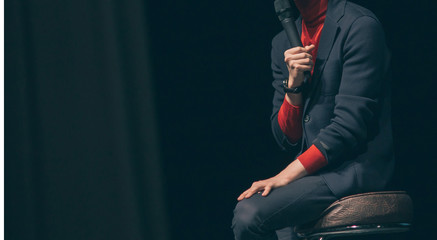 cropped image. businessman reading a report at a business seminar.