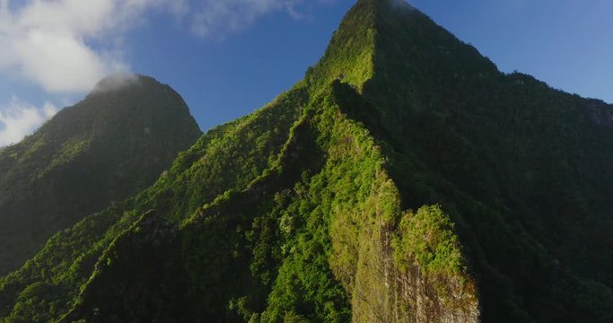 Aerial drone shot of amazing lush green island mountain peak, island landscapes