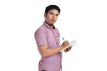 Asian male writing on his diary with pink t-shirt