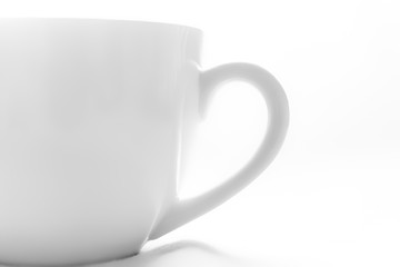 Close up of empty white cup on white background.