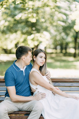 Naklejka premium Happy people enjoy the good weather. Beautiful couple walking in the Park in the summer.