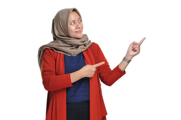 Excited expression of happy smiling asian woman pointing of a copyspace