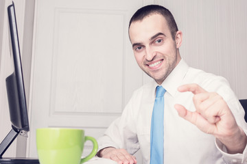 Cheerful businessman gesturing a small amount, front view, close up, toned