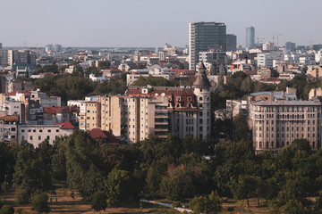 Fototapeta na wymiar Cityscape of old part of Bucharest, with many worn out buildings, as seen from the Palace of Parliament