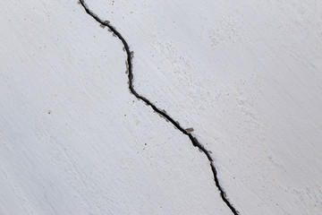 Massive crack in the wall concrete in extreme closeup. Concept blueprint for destruction, lose or broken soemetheing.