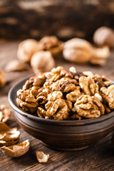 Walnuts. Kernels and whole nuts on wooden rustic table