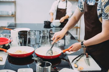 culinary master class for cooking pasta with mussels. close-up of hands