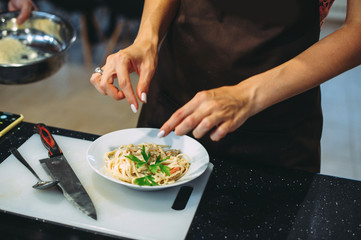 culinary master class for cooking pasta with mussels. close-up of hands