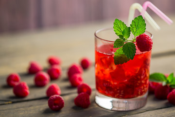 Glass of fresh strawberry smoothie and fresh strawberries on the wooden background. Healthy food and drink concept.
