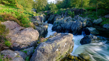 The old packhorse bridge known as Birk's Bridge across the river Duddon near Seathwaite in the Lake District National Park.