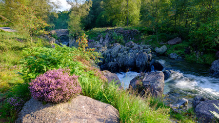 The old packhorse bridge known as Birk's Bridge across the river Duddon near Seathwaite in the Lake District National Park.