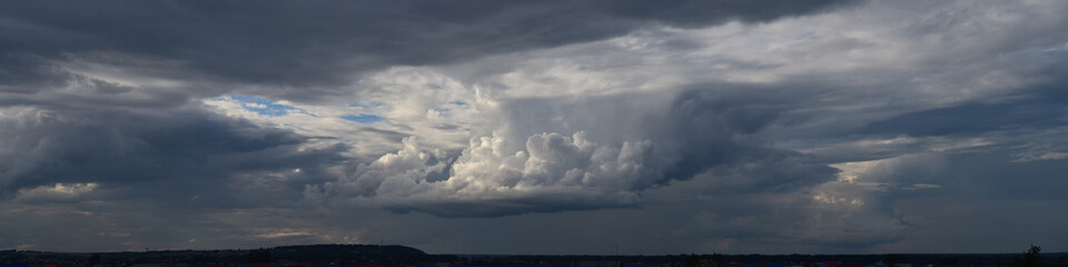 Photo of the cloudy sky. Horizon, moisture-bearing and vapor-forming atmospheric phenomenon, panoramic image.