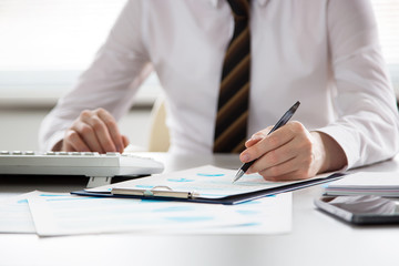 Serious businessman working with computer
