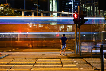 夜の近未来的な高層ビル群で遭遇する透き通る光る乗り物