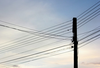 Fototapeta premium Electric poles and electrical wires before​ sunset​ in​ Chiangmai.