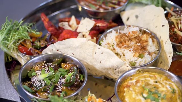 North indian rich thali continental meal cuisine, close up panning shot