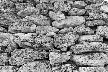 The wall is made of old large stones.