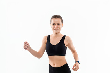 Young sporty blond woman in a black sportswear running isolated over white background.