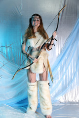 girl dressed as a cave woman with a bow and arrow
