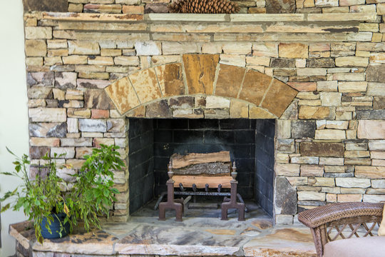 Back Stone Patio Porch Of Large Home With An Outdoor Fireplace